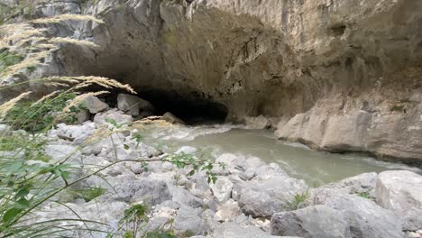 Powerful-river-rapids-run-through-a-dark-cave-in-the-canyons-of-France