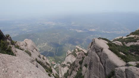 young-woman-walking-in-the-national-park-of-montserrat-mountain,-barcelona,-spain,-drone-shot,-wellness-and-nature-concept