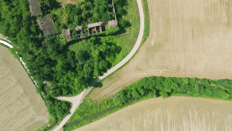 agricultural landscape near abandoned buildings with dilapidated roofs in italy