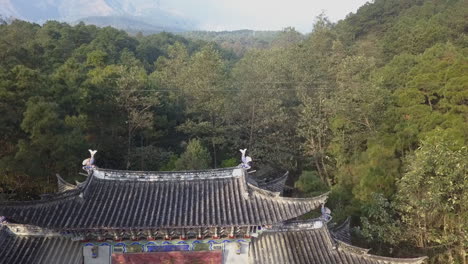 Retreating-forest-aerial-reveals-gate-to-Wu-Wei-Si-temple-in-China