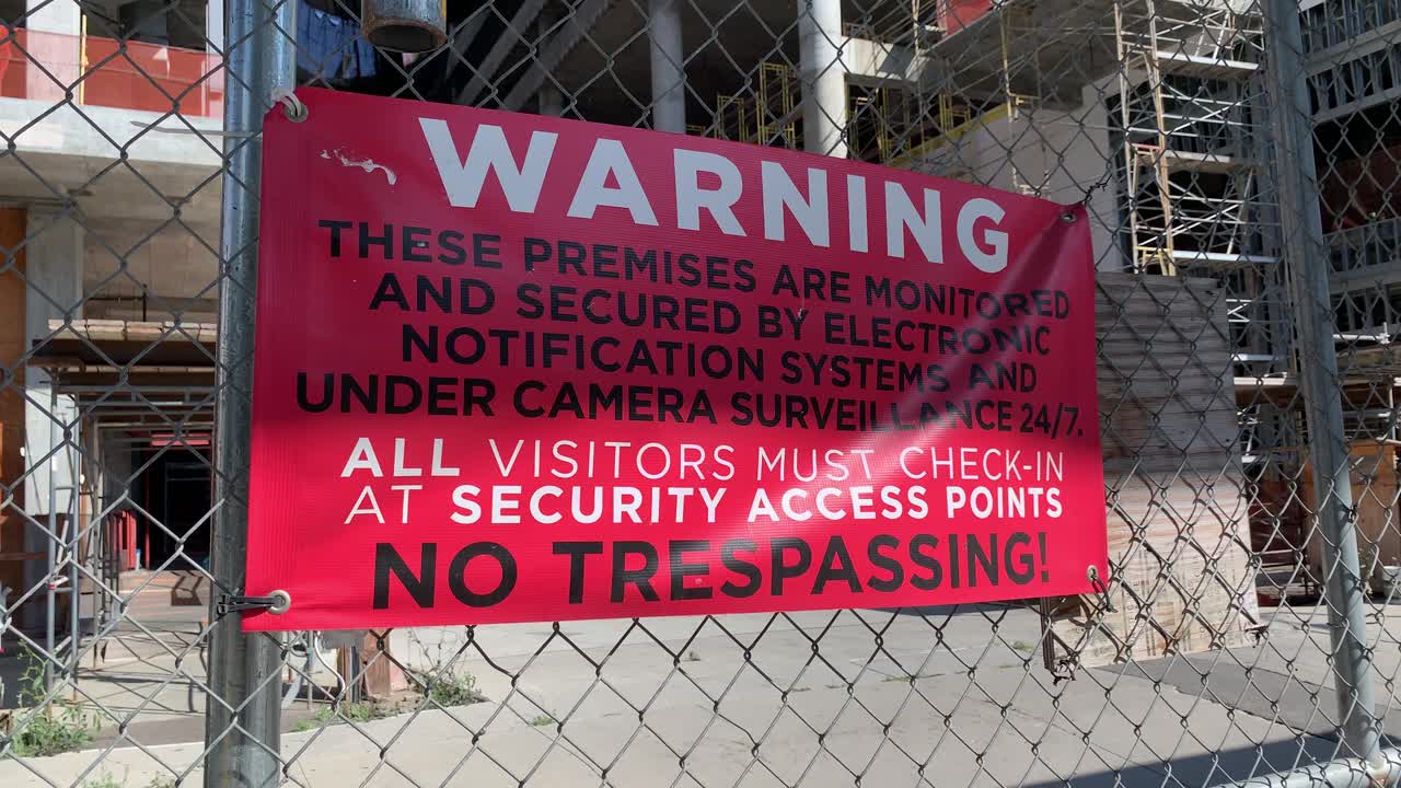 No trespassing sign on side of building