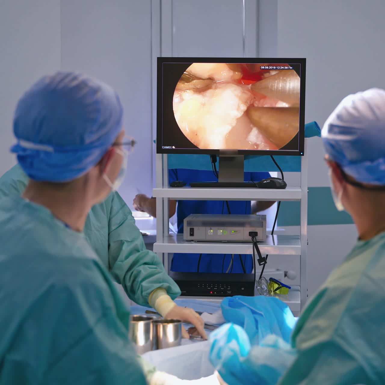 Operating process on the screen of a computer. Surgeons use a tool with ...