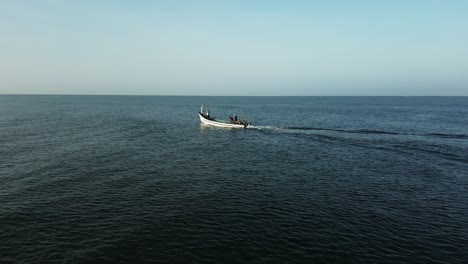 Fisher men on their dungi going for work in the morning in Goa, India