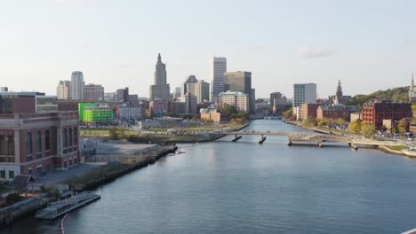 Looking-down-the-river-at-the-city-center-of-Providence,-Rhode-Island-city-center-and-business-district---aerial-view