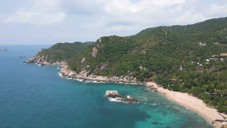 slow drone push out over beautiful beach on tropical thai island