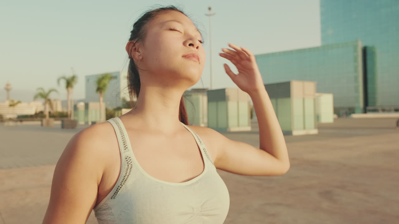 Asian woman stretching outdoors in the city