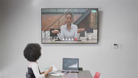 African-american-businesswoman-on-video-call-with-african-american-female-colleague-on-screen