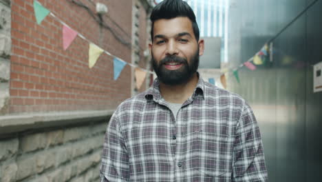 smiling man in an urban alley