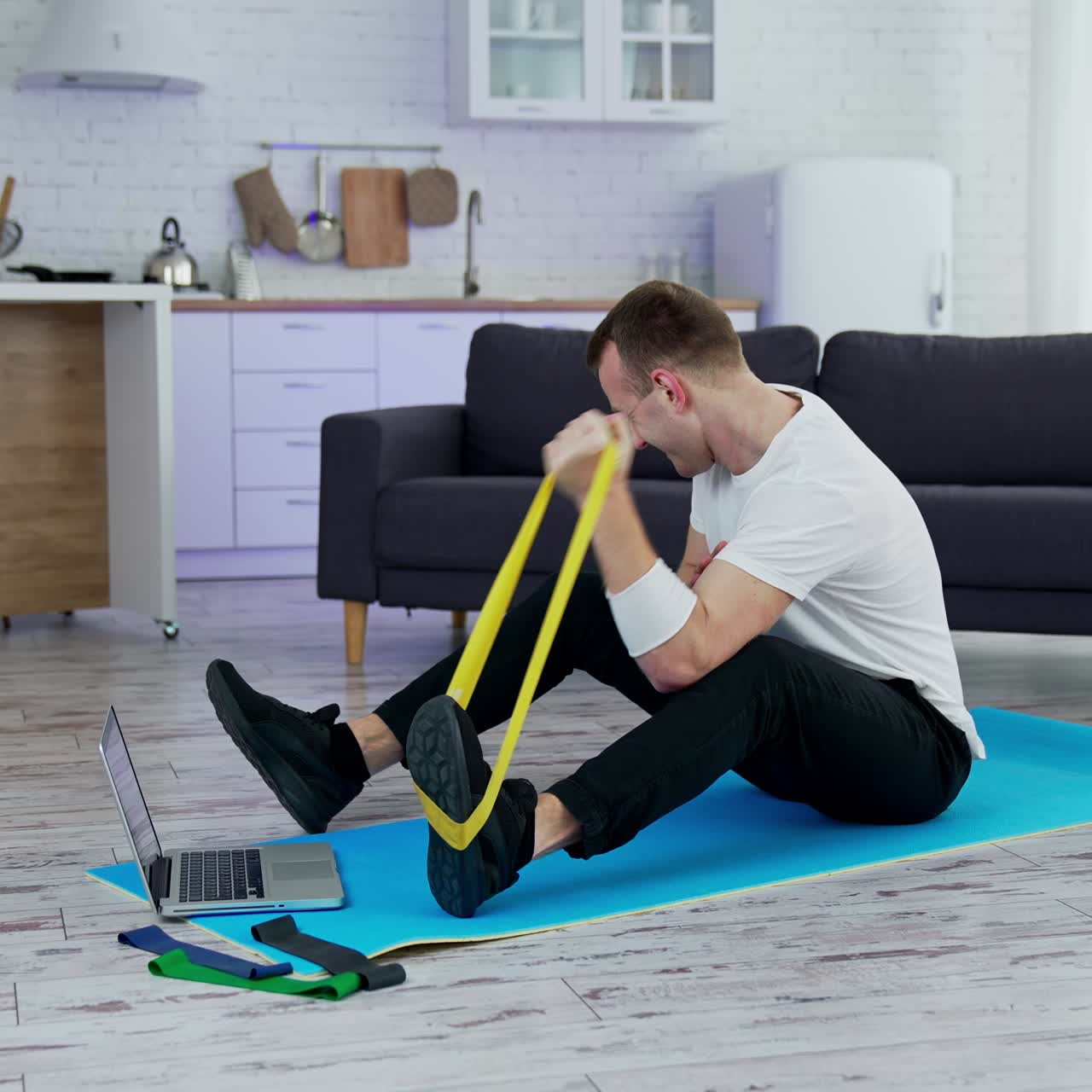 Training body indoor by strong handsome man. Young lifestyle sportsman working out at home