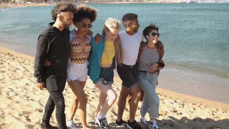 trendy young friends strolling on beach