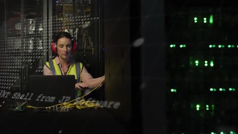 animación del procesamiento de datos sobre una mujer caucásica trabajando en una computadora portátil en la sala de servidores