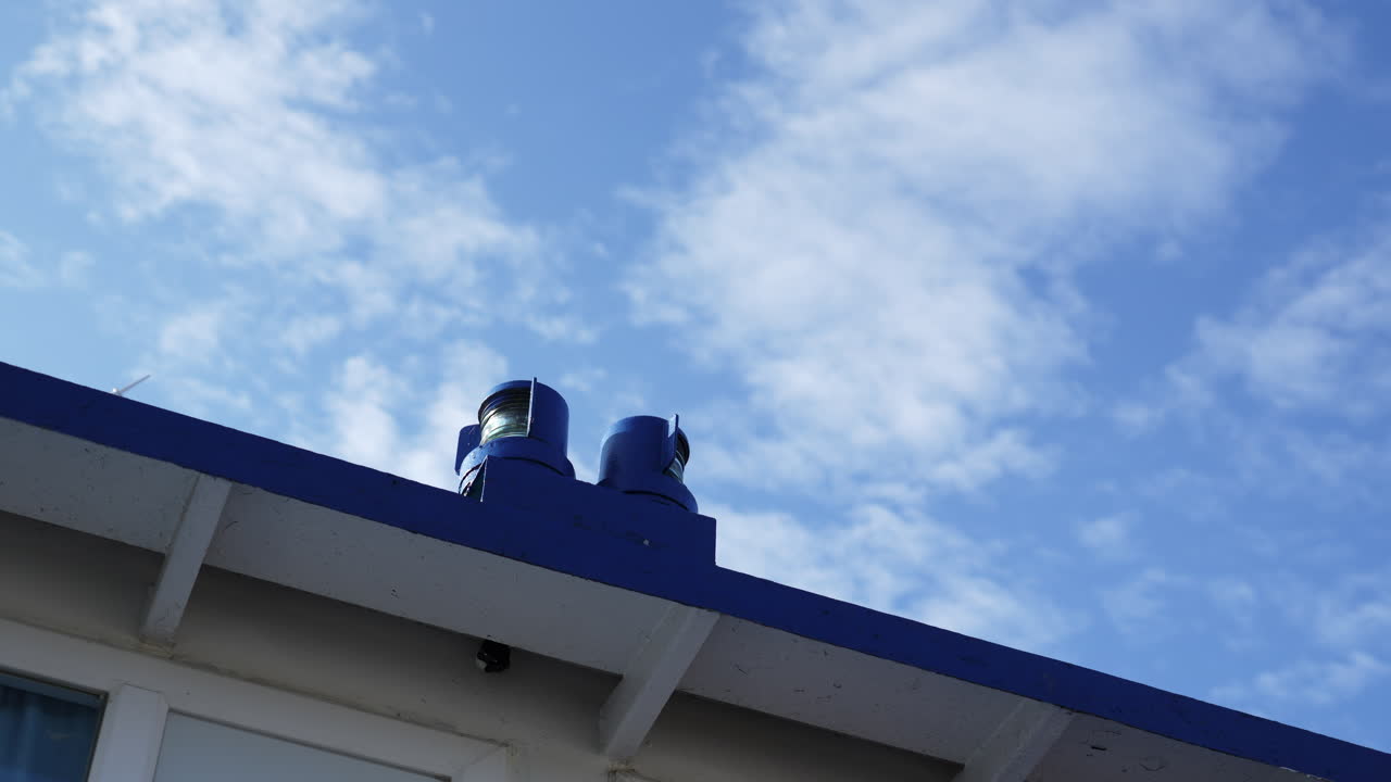 Navigational lights on a building against a cloudy sky