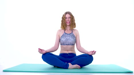 young curly woman in nature in easy yoha pose, sukhasana with gyan mudra finger gesture, static studio view