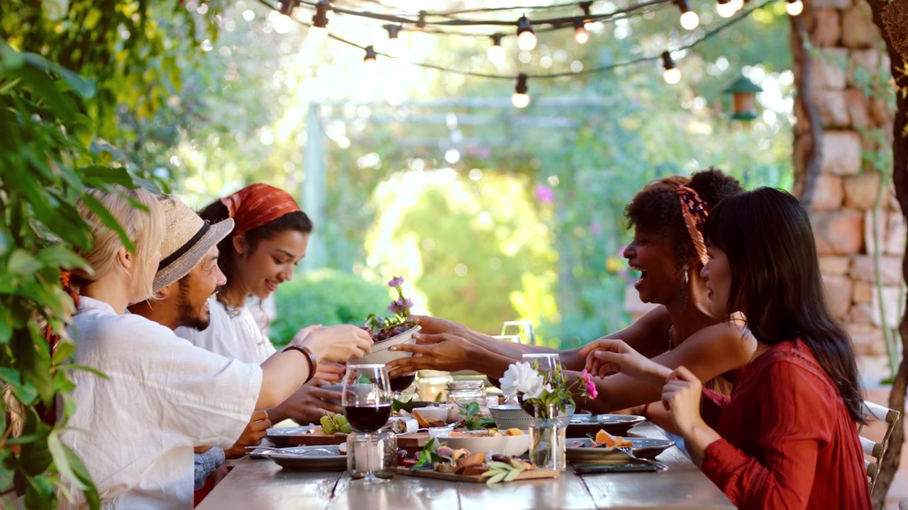 Diverse Group of Friends Sharing a Meal Outdoors