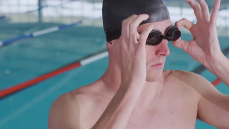 swimmer putting his pool goggles