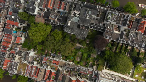 Overhead-Birds-View-of-Amsterdam,-Netherlands-Neighbourhood-with-Green-Trees-and-Red-Rooftops