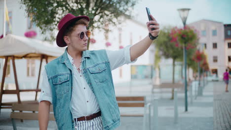 stylish man taking a selfie in a city street