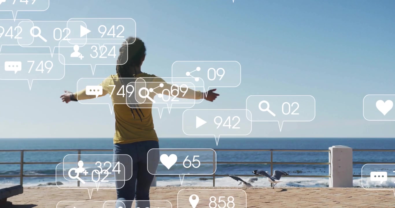 Beachfront woman gazing ocean receiving growing social media icons and raising arms for engagement