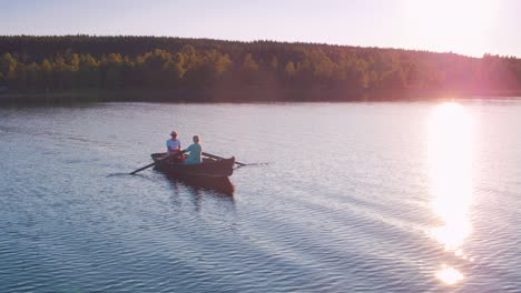 cinematic shot of a couple rowing at sunset