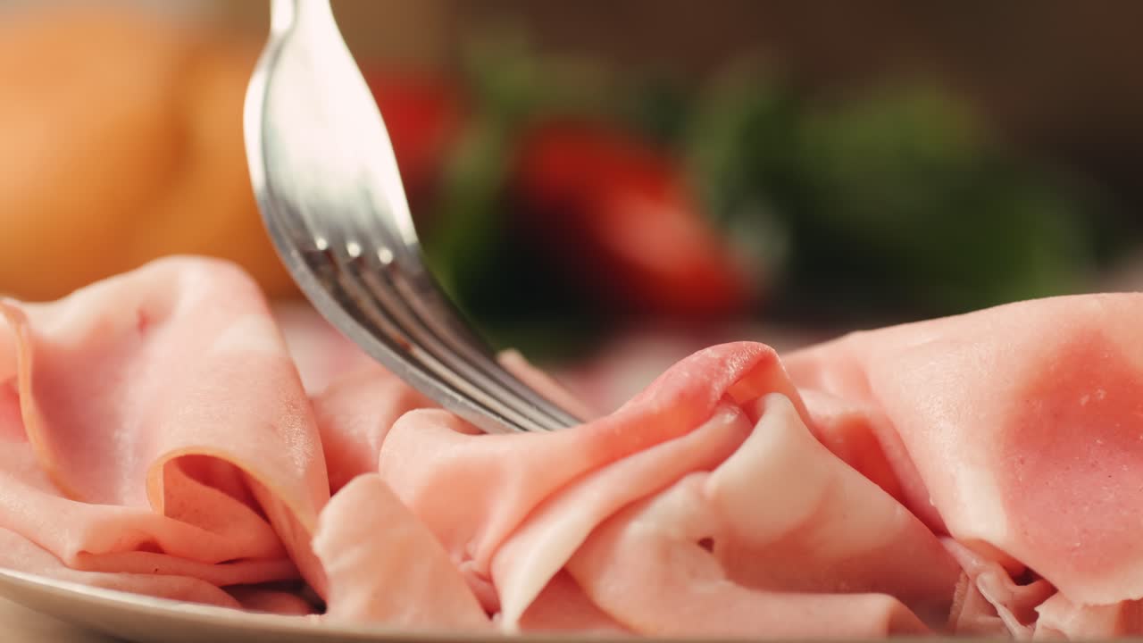 Ham italian mordatella, man Slices Of Traditional Italian antipasti mortadella sausage on a wooden cutting board, close up macro of chicken or turkey jamon, fat breakfast dish.