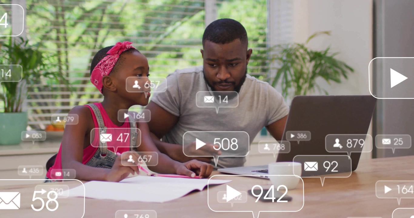 Father and Daughter Using Laptop with Social Media Notifications