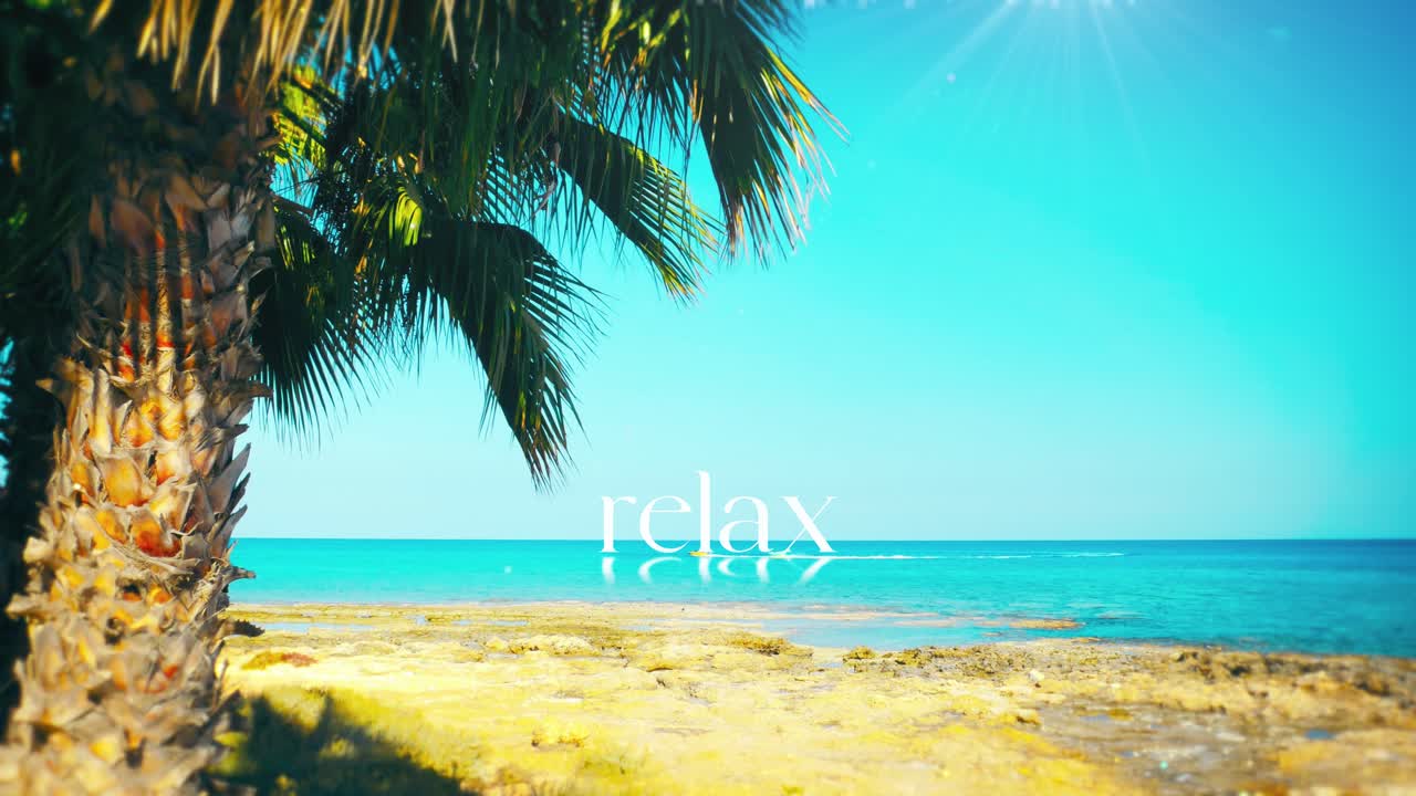 Peaceful footage for ultimate RELAXATION. Tropical beach, clear water, and the word reflecting on the ocean. Ideal for spa, wellness, meditation content, or calming video backgrounds