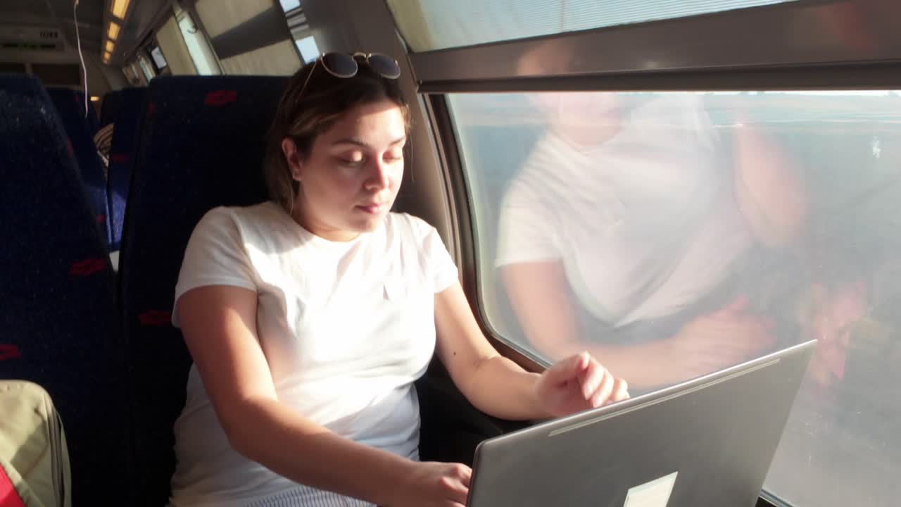 Tired Woman Waking Up and Rubbing Her Eyes on a Train