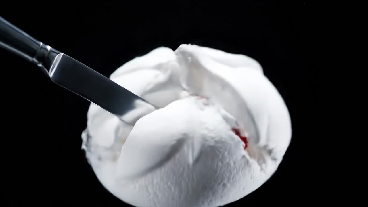 Meringue with knife and black background