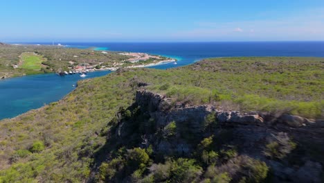 Aerial dolly reveal of Seru Kabritu with resort in the background, capturing Curacao's beautiful coastal landscape