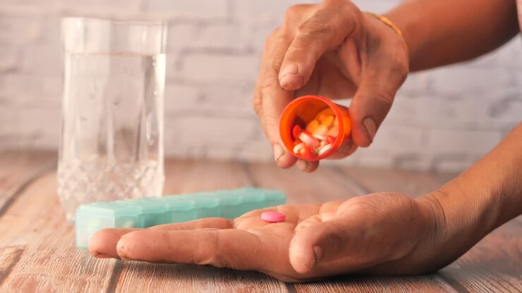 Person taking pills with water