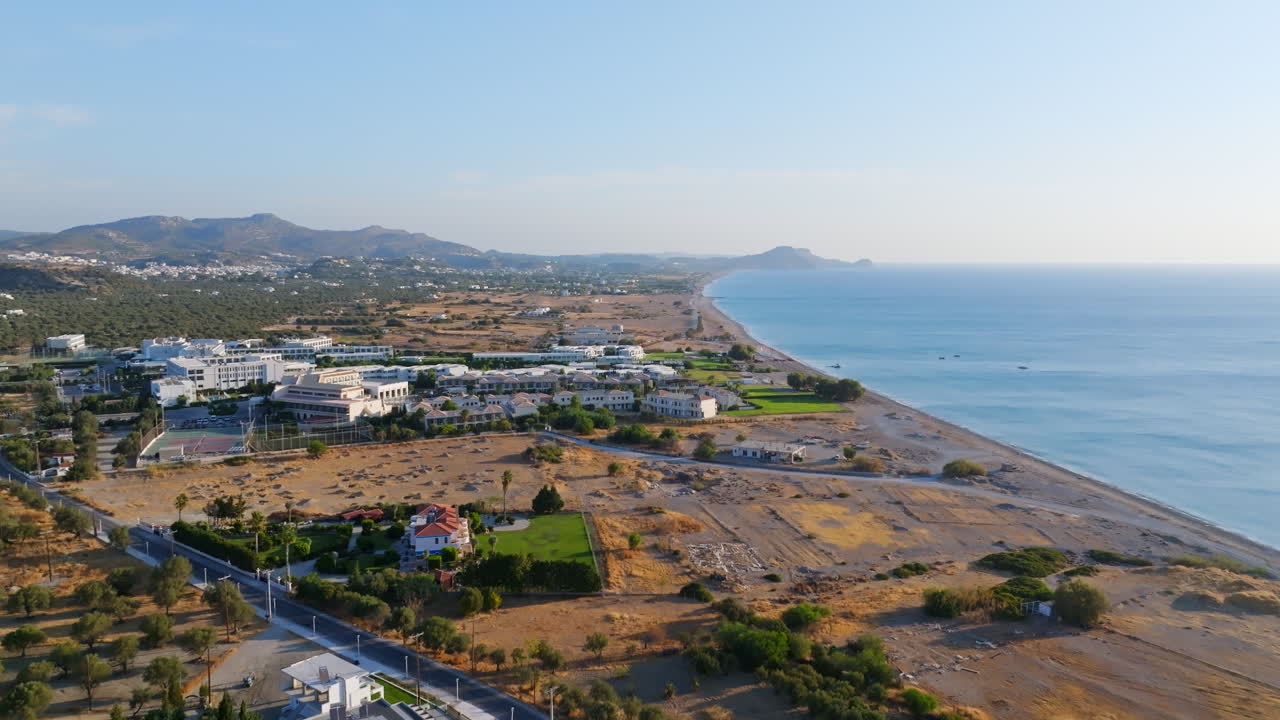 Aerial tilt shot overlooking the coastline of Afandou, sunrise in Rhodes, Greece