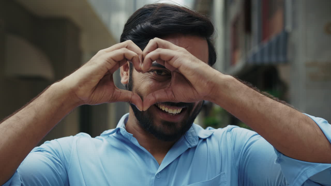 hombre haciendo forma de corazón con las manos