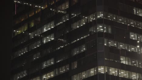 skyscraper office building light show in shibuya at night during rain, tokyo, japan