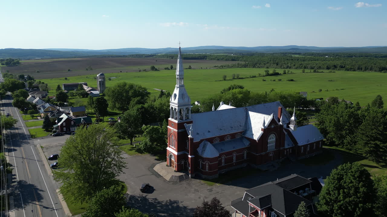 Aerial View of a Small Village with a Red Brick Church
