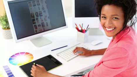 Pretty-photo-editor-working-with-digitizer-at-her-desk