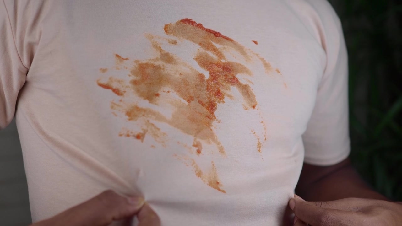 Close-up of a Large Food Stain on a Light Colored T-Shirt
