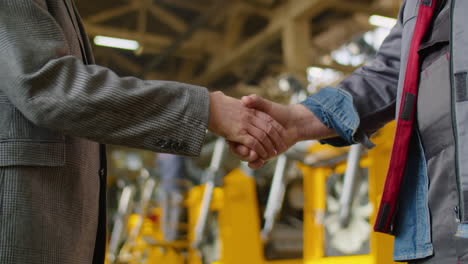 handshake of engineer and factory worker