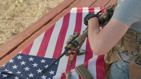male hands dismantling sniper rifle