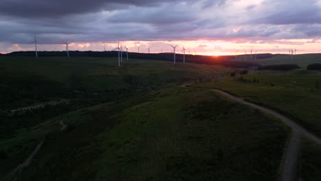 aerial footage of windfarm at sunset