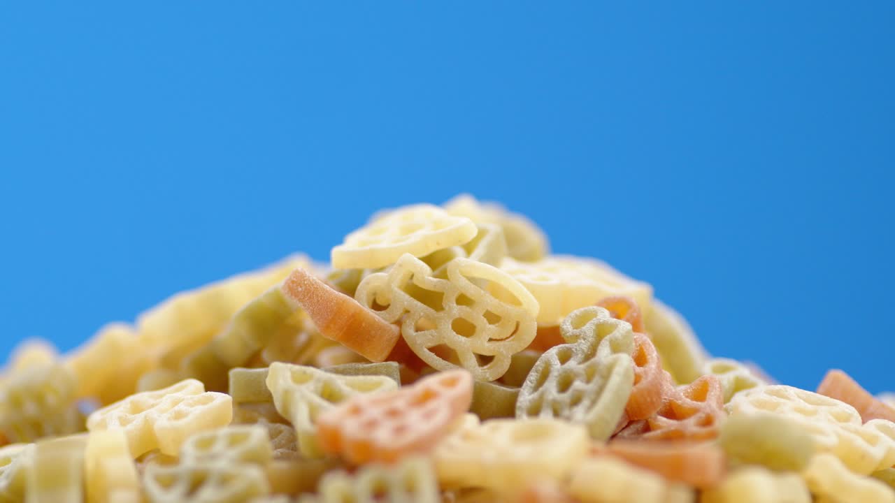 Rotelle dry pasta in a heap slowly rotates.