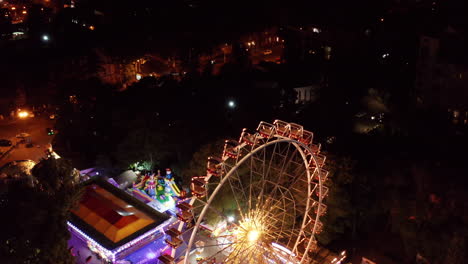 Aerial-drone-view-above-gigantic-Ferris-wheel-in-Odessa,-Ukraine,-tilt-down