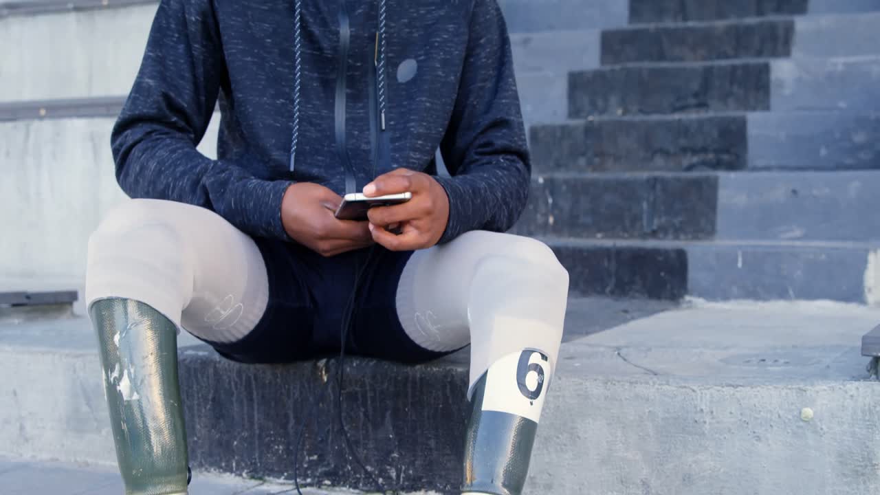 Disabled athletic listening music on mobile phone 4k