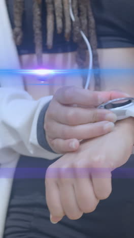 animation of blue light beams over midsection of woman using smartwatch