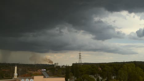 Slow-left-pan-of-heavy-dark-storm-clouds-over-Parnitha-and-Penteli-mountains,-Greece,-Forest-fire-due-to-lightning-strike-4K