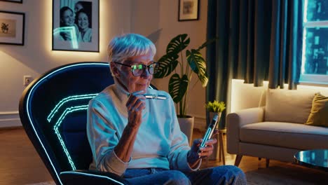 senior woman using electronic cigarette at home