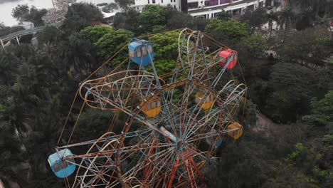 Flying-around-old-abandoned-ferris-wheel-at-Hanoi-Vietnam,-aerial