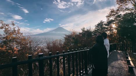 couple taking photos of mount fuji during autumn