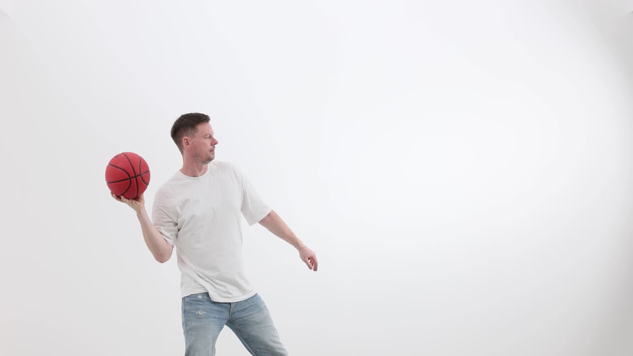 Man throwing a basketball on a white background