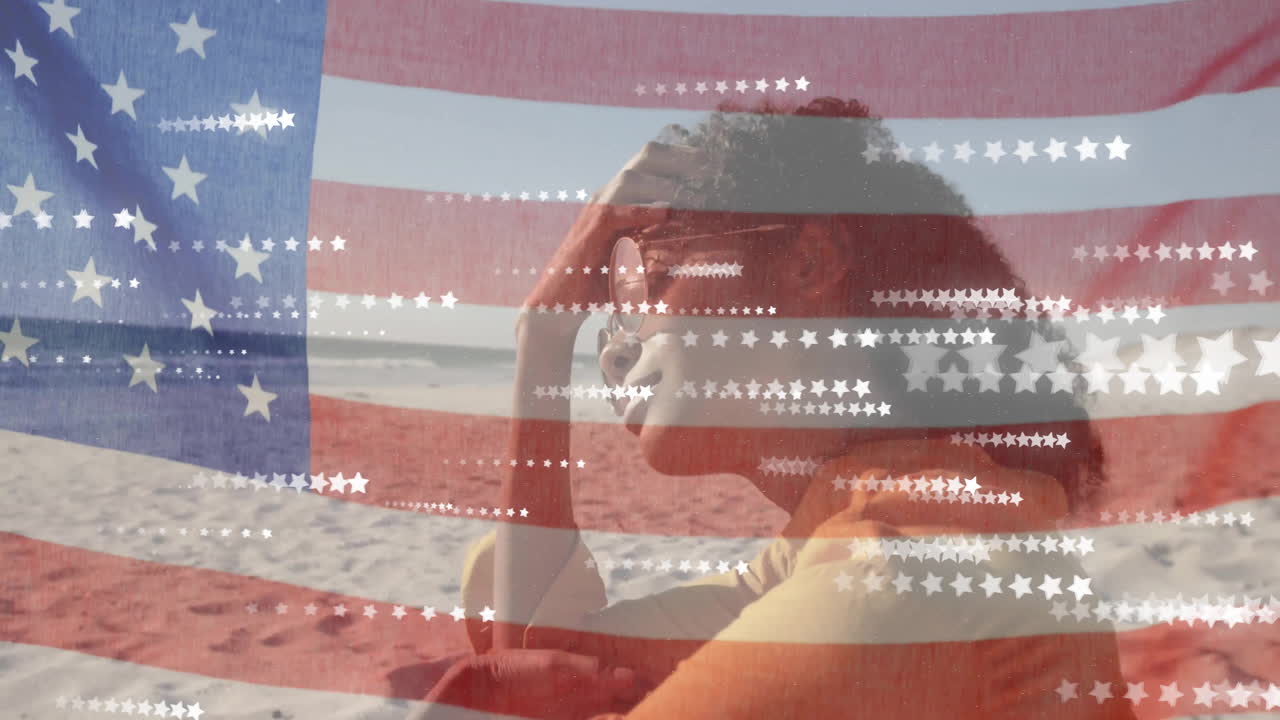 animación de la bandera estadounidense y las estrellas sobre feliz mujer afroamericana relajándose en una playa soleada