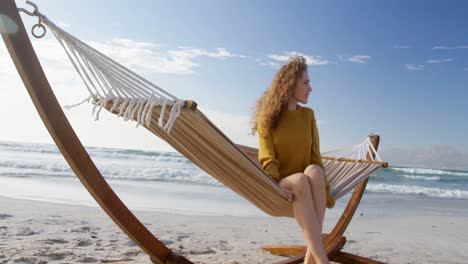 Woman-relaxing-in-hammock-at-beach-4k